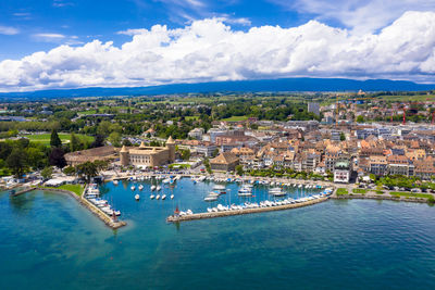 High angle view of sea and buildings against sky