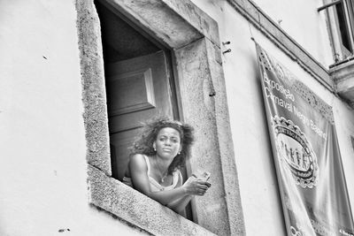 Portrait of smiling young woman using mobile phone