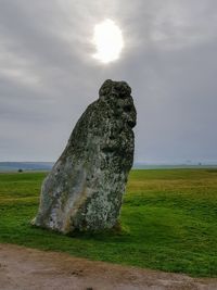 Scenic view of rocks on field against sky