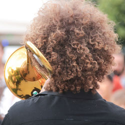 Rear view of man playing music