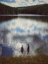 Rear view of couple walking in lake