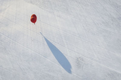 High angle view of heart shape hot air balloon on snow covered land