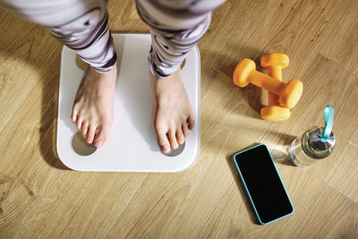 Low section of woman using laptop on table