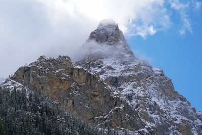 Low angle view of snowcapped mountain against sky