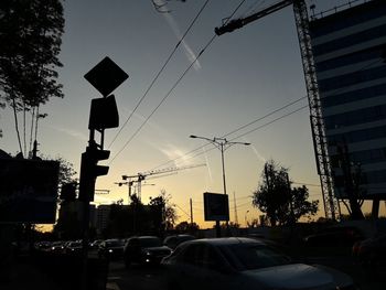 Traffic on road at sunset