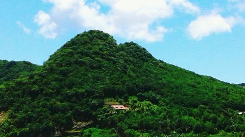 Scenic view of mountains against blue sky