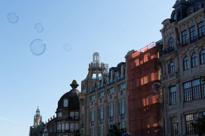 Low angle view of buildings against blue sky