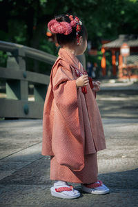 Rear view of woman standing on street