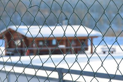 Close-up of chainlink fence against sky