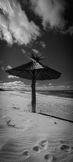 Lifeguard hut on beach against sky