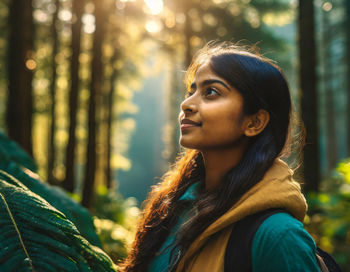 Walking through a dense forest. sunlight streaming through the leaves.