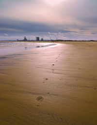 Scenic view of beach against sky during sunrise