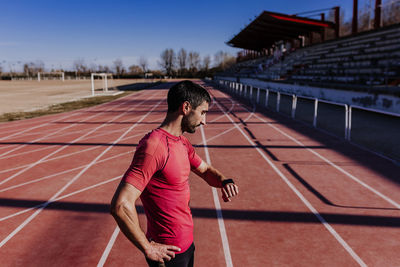 Side view of athlete standing on sports track