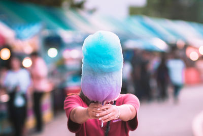 View of young woman holding candy