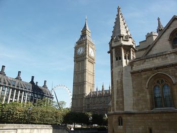 Low angle view of clock tower in city