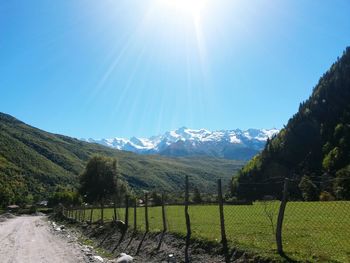 Scenic view of mountains against clear blue sky