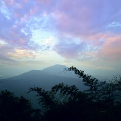 Scenic view of mountains against cloudy sky