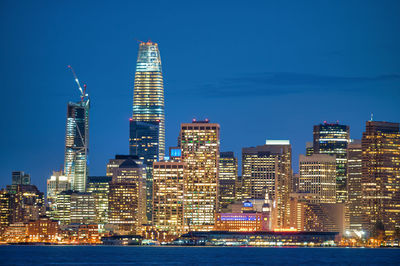 Illuminated buildings against sky at night