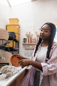 Woman washing her pottery at the ceramics studio