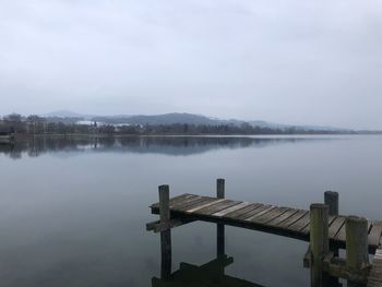 Pier over lake against sky