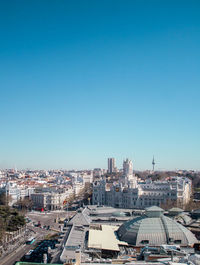 High angle view of buildings against blue sky