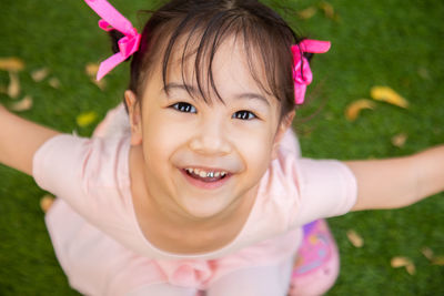 Portrait of a smiling girl with pink face