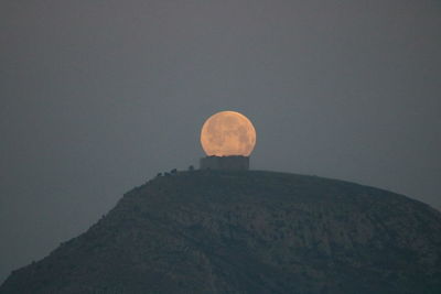 Low angle view of moon against sky at night