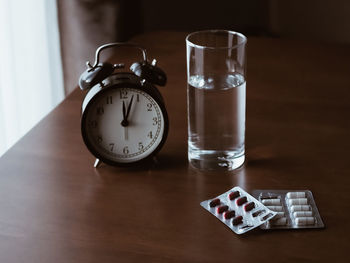 High angle view of clock on table