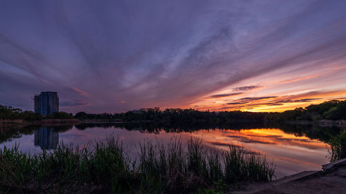 Scenic view of lake against romantic sky at sunset