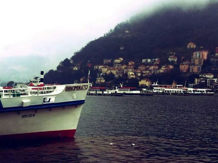 water, nautical vessel, sea, waterfront, boat, transportation, mode of transport, mountain, sky, building exterior, built structure, architecture, moored, nature, tranquil scene, scenics, tranquility, beauty in nature, river, day