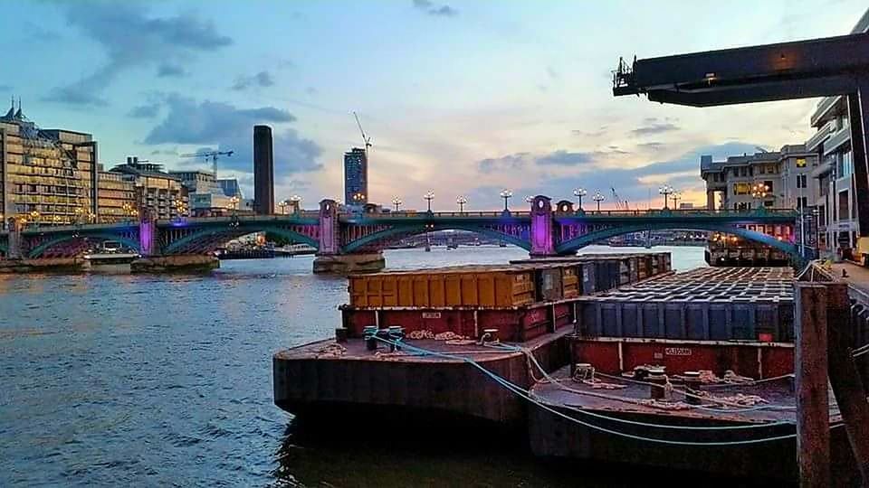 BOATS MOORED IN RIVER AGAINST SKY