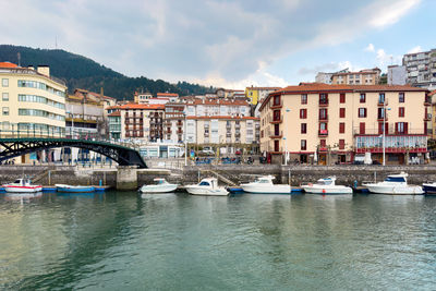 Boats in river in city