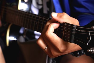 Close-up of hands playing guitar