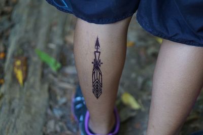 High angle view of person with tattoo on leg