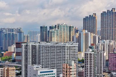 Cityscape against cloudy sky