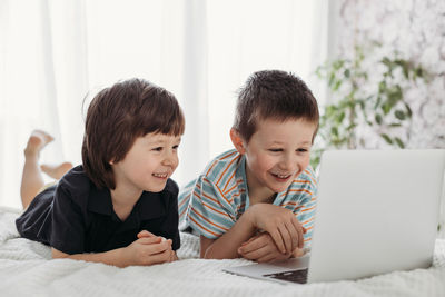 Online training. boys watch lessons on a laptop. children use gadgets in everyday life. 
