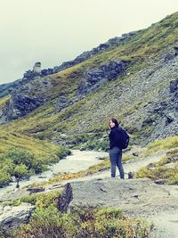 Full length of man on rock against sky