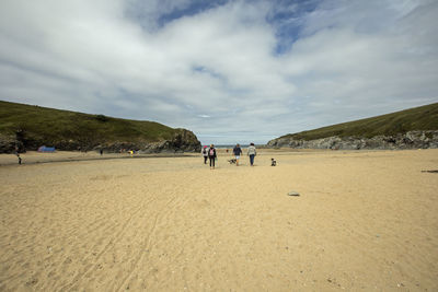 People on beach against sky