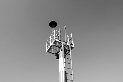 Low angle view of communications tower against clear sky