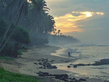 Scenic view of beach against sky during sunset