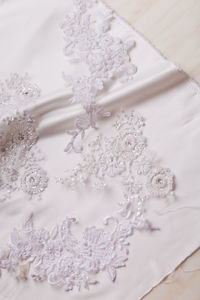 High angle view of embroidery on white fabric