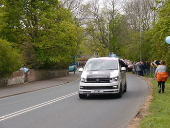 Cars on road by trees