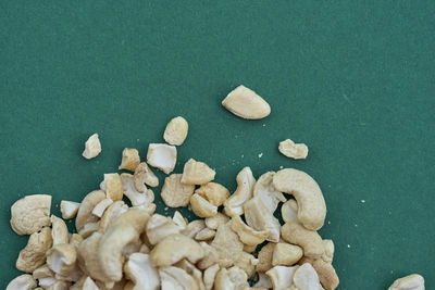 Close-up of cashew nuts against green background
