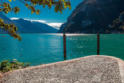 Scenic view of sea and mountains against blue sky