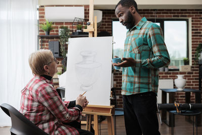 Side view of man working in office