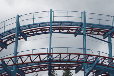 Low angle view of roller coaster against sky