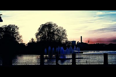 Silhouette of railing against sunset
