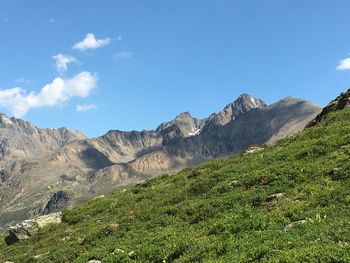 Scenic view of mountains against blue sky