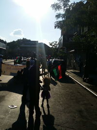 People walking on street during sunny day