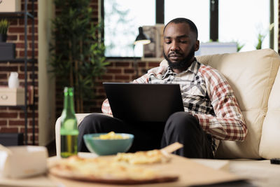 Young man using laptop at table